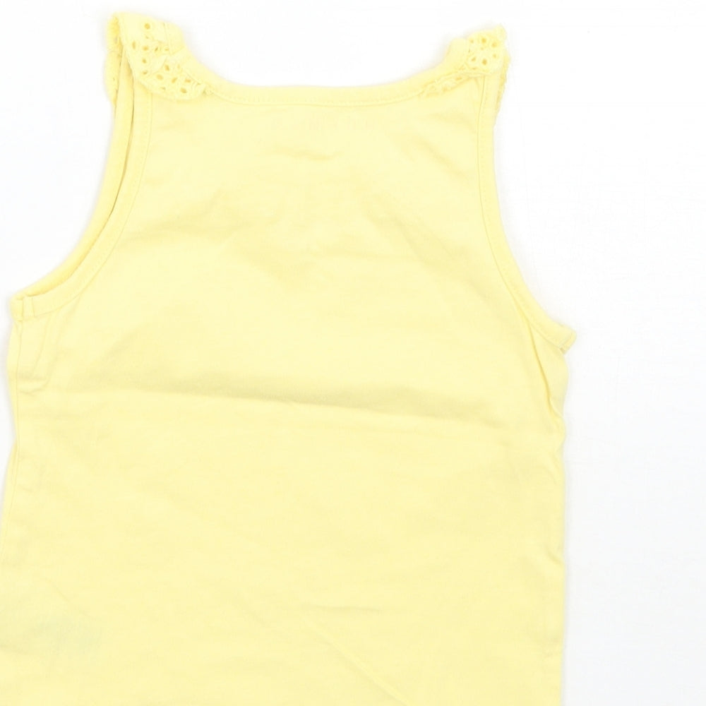 Brand and care label for Nutmeg girls’ yellow basic tank, size 12-18, months