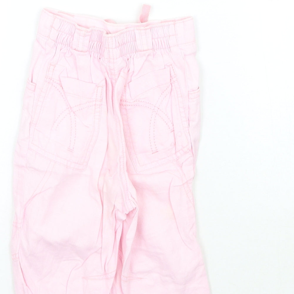 Brand and care label for Next girls’ pink capri trousers, size 12-18, months