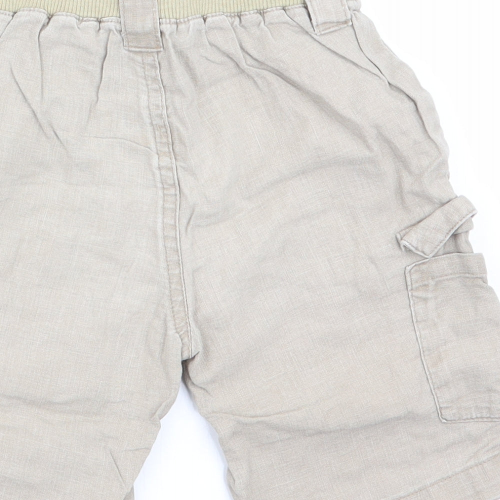 Brand and care label for Mothercare boys’ beige cargo trousers, size 12-18, months