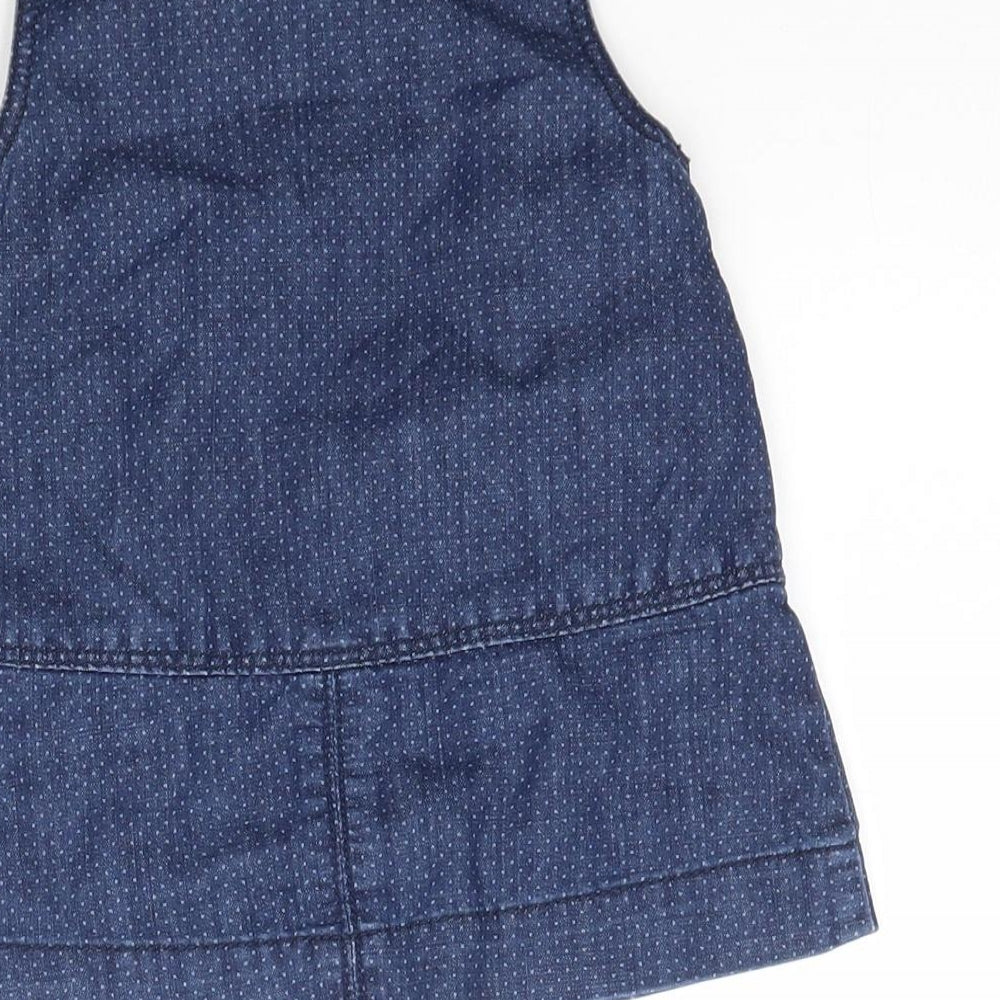 Brand and care label for Obaibi girls’ blue polka dot denim pinafore/dungaree dress, size 12, months