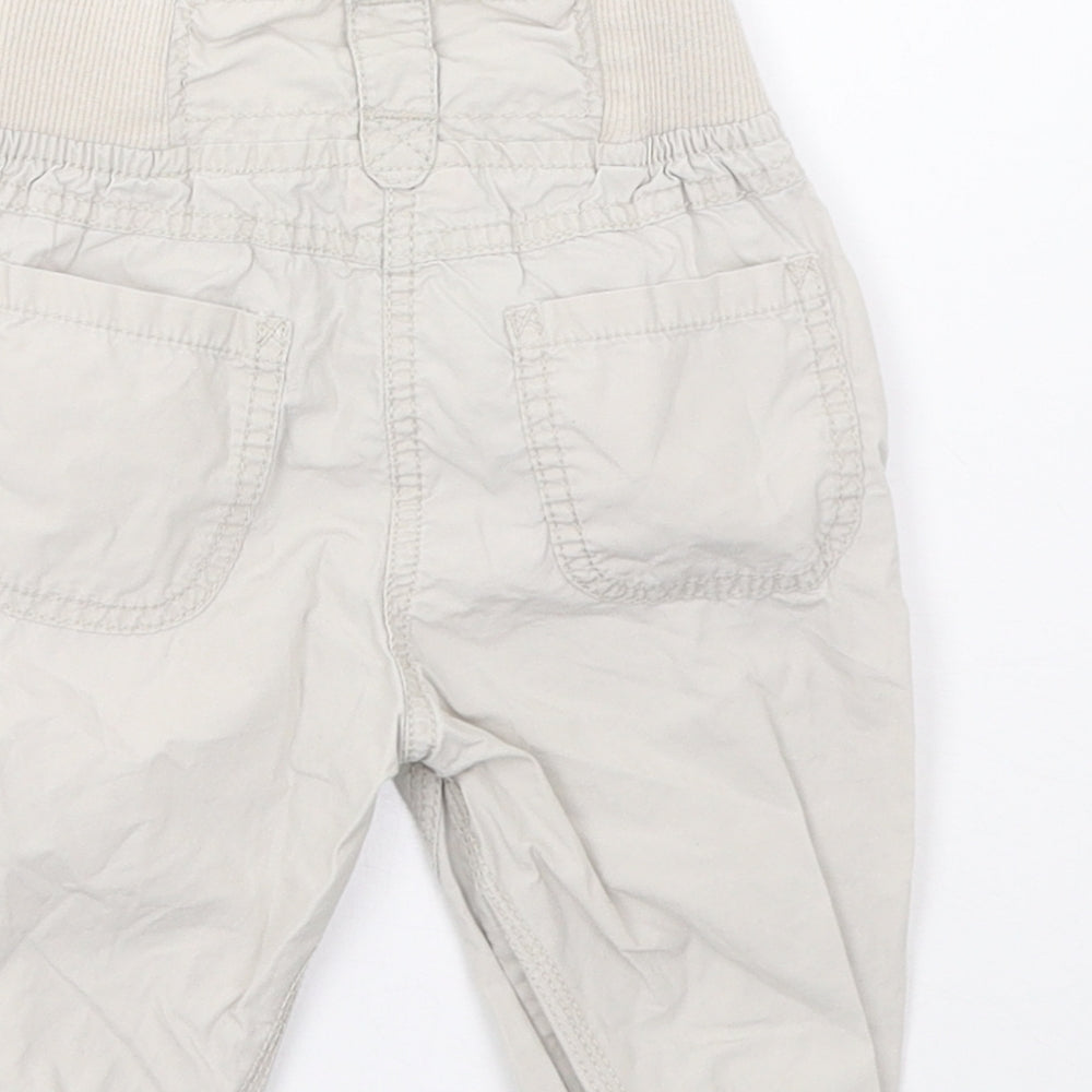 Brand and care label for Cherokee girls’ beige cargo trousers, size 12-18, months