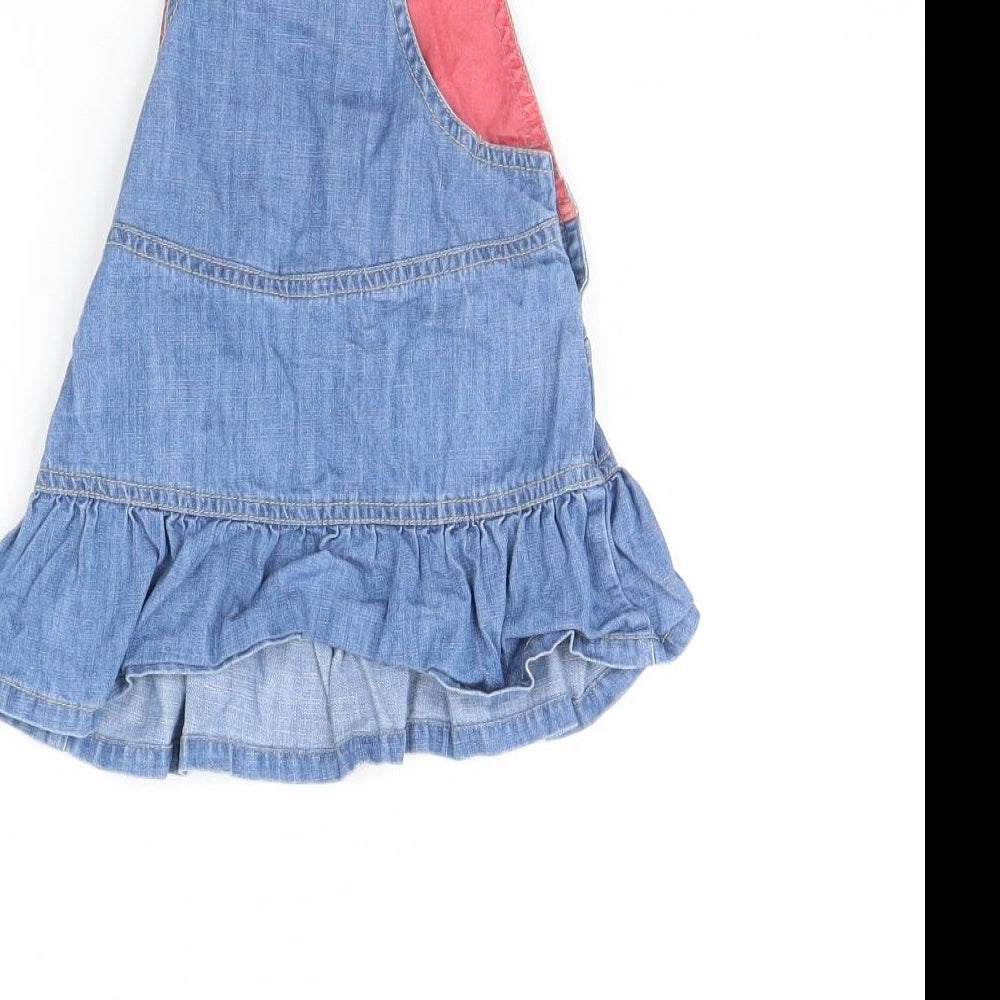Brand and care label for Mini Club girls’ blue denim pinafore/dungaree dress, size 3-6, months
