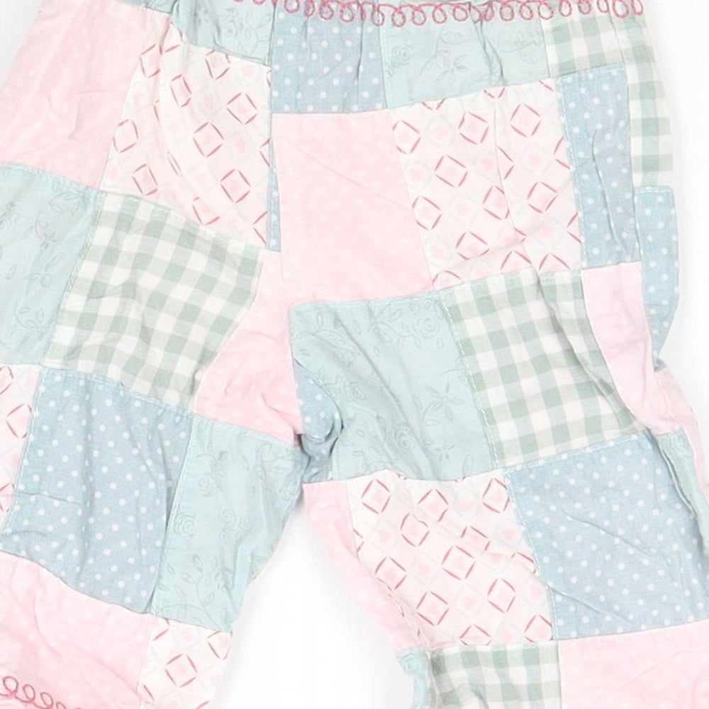 Brand and care label for Next girls’ grey geometric sweatpants, size 3-6, months