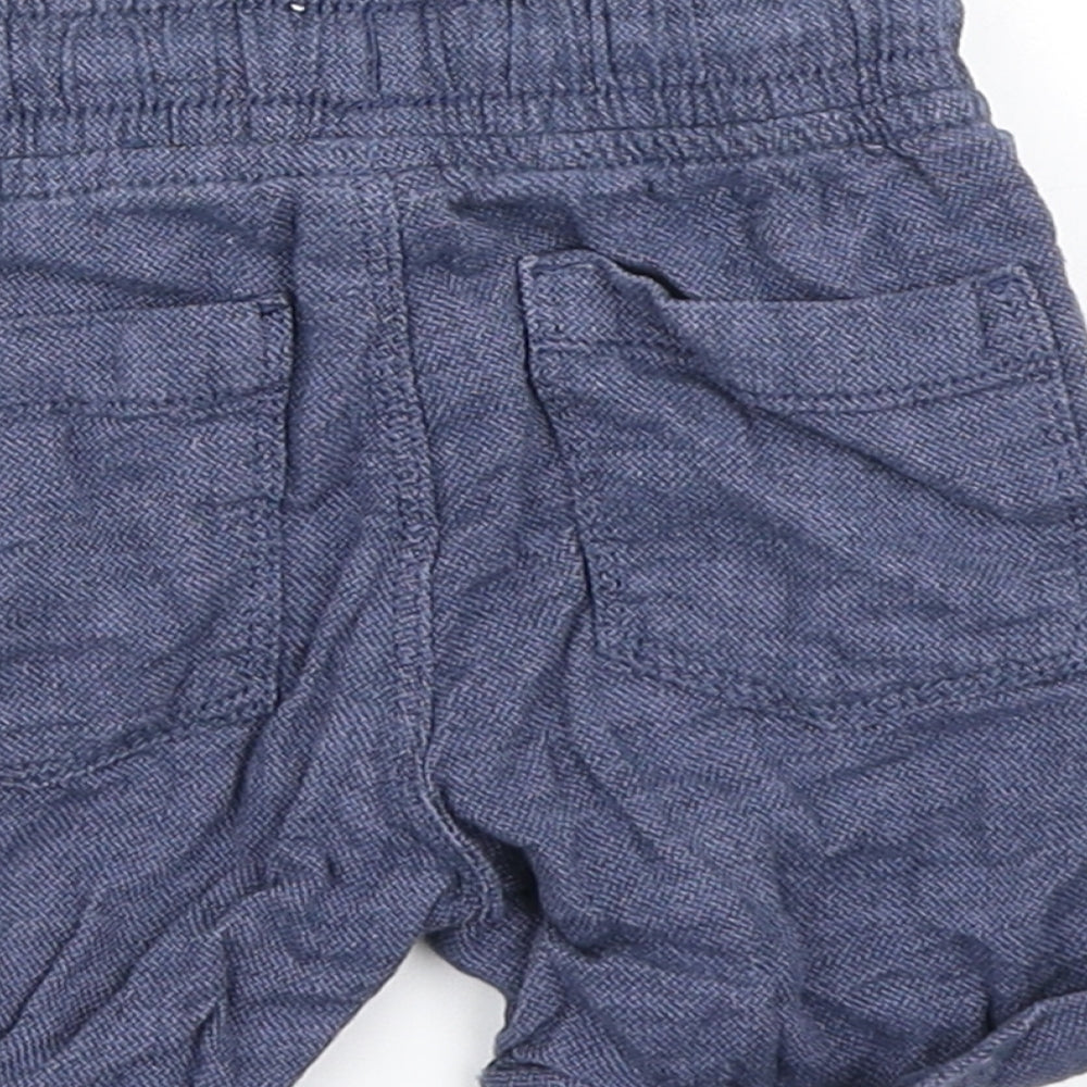 Brand and care label for Tu boys’ blue cropped trousers, size 9-12, months