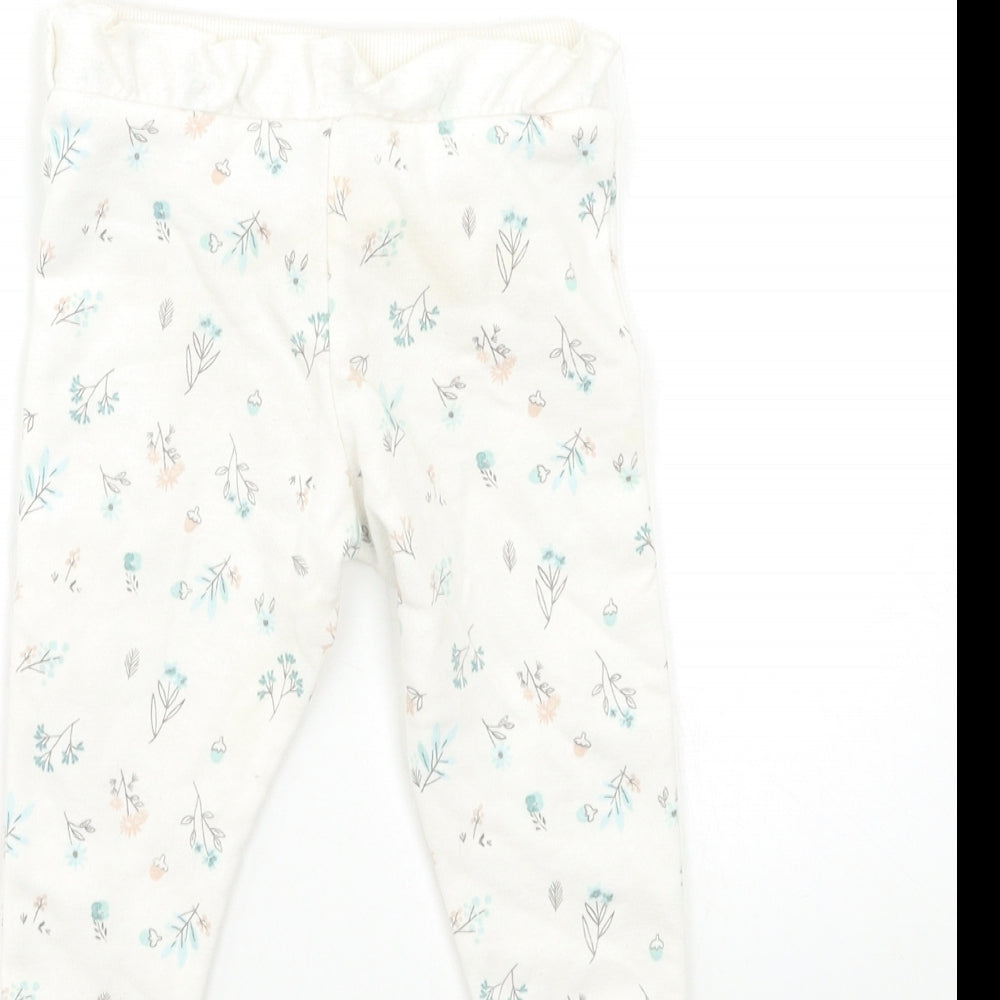 Brand and care label for Primark Baby White Floral Jogger Trousers, size 9-12, Months