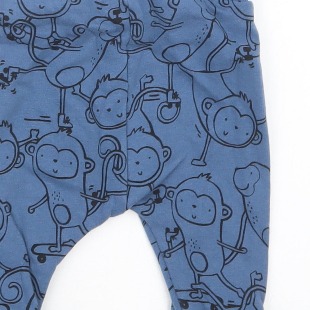 Brand and care label for Next boys’ blue geometric jogger trousers, size 3-6, months