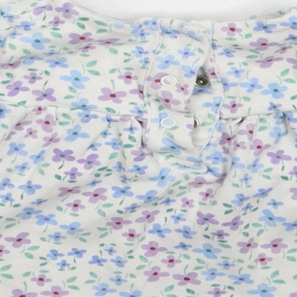 Brand and care label for Marks & Spencer girls’ white floral fit & flare, size 6-9, months
