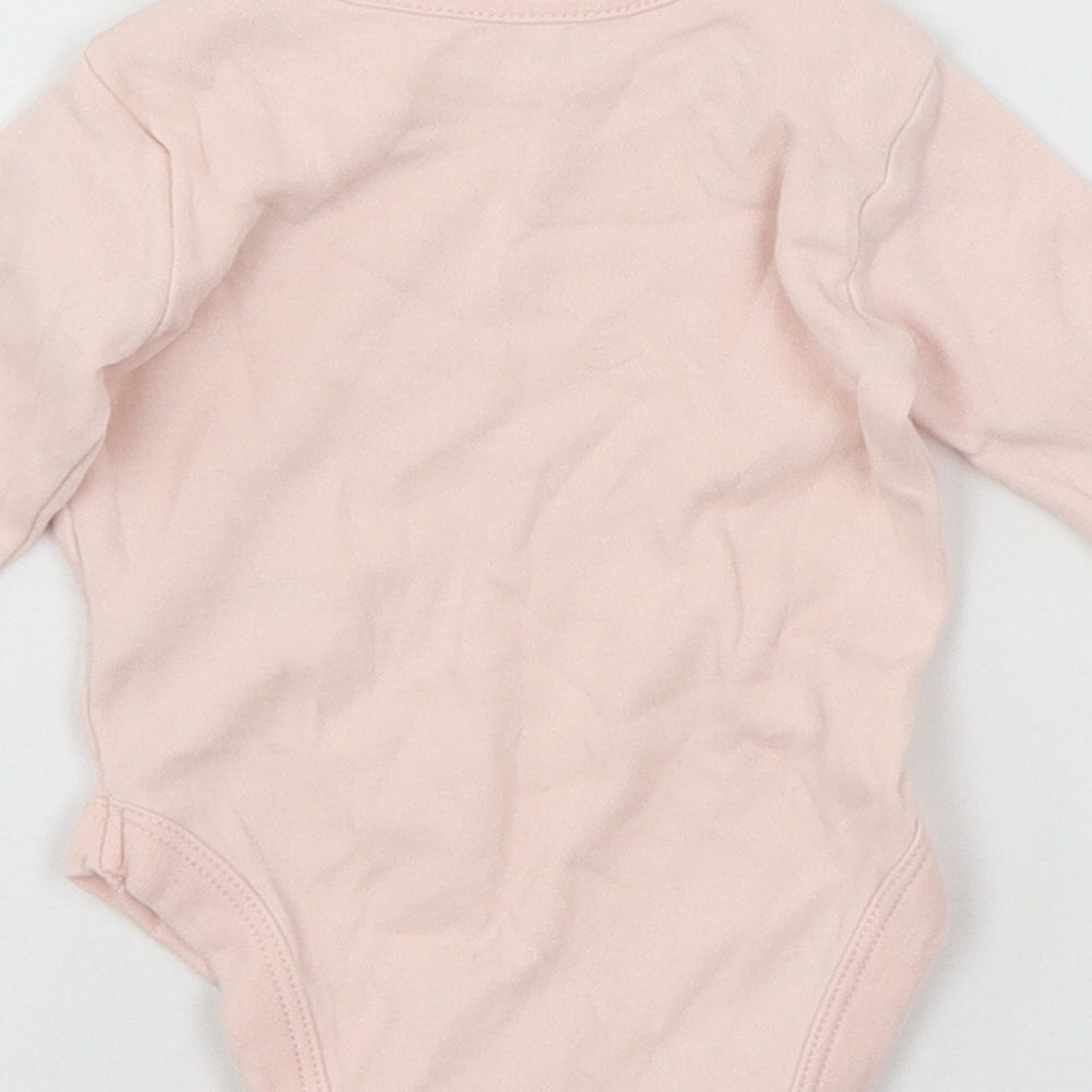 Brand and care label for George girls’ pink jersey babygrow one-piece, size 0-3, months