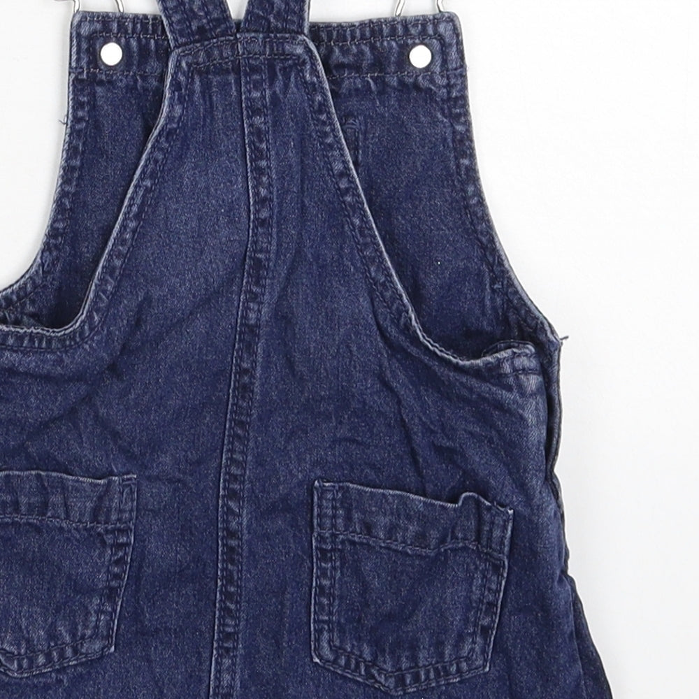 Brand and care label for Maine New England girls’ blue denim pinafore/dungaree dress, size 12-18, months