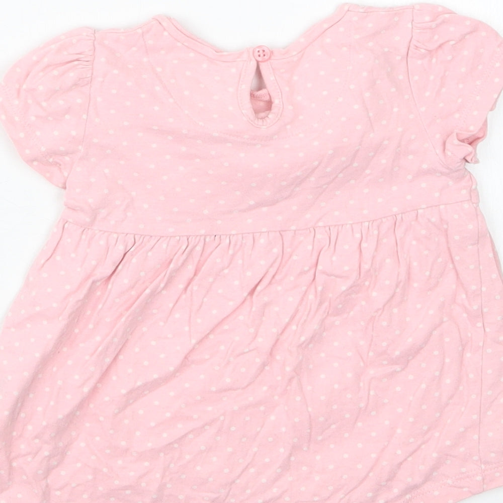 Brand and care label for Mothercare girls’ pink polka dot basic t-shirt, size 3-6, months