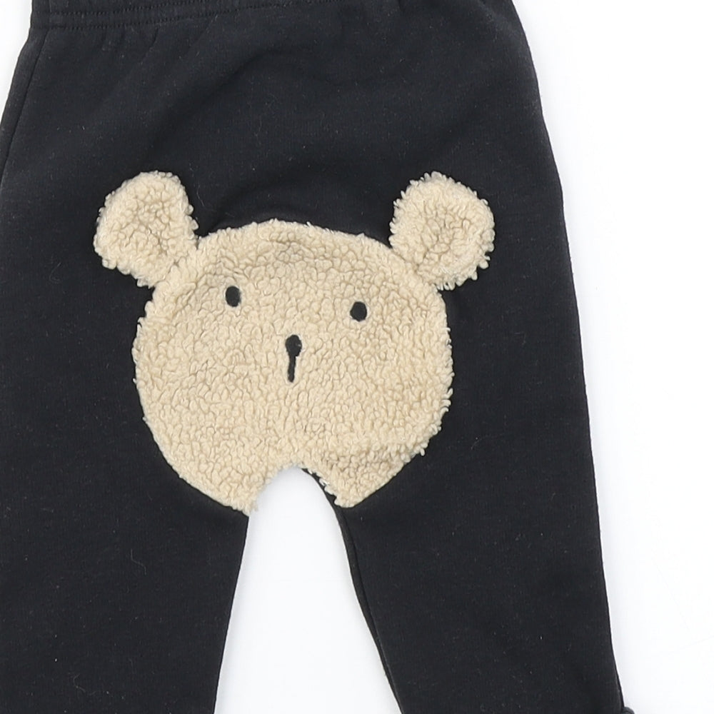 Brand and care label for Nutmeg boys’ black jogger trousers, size 3-6, months - bear