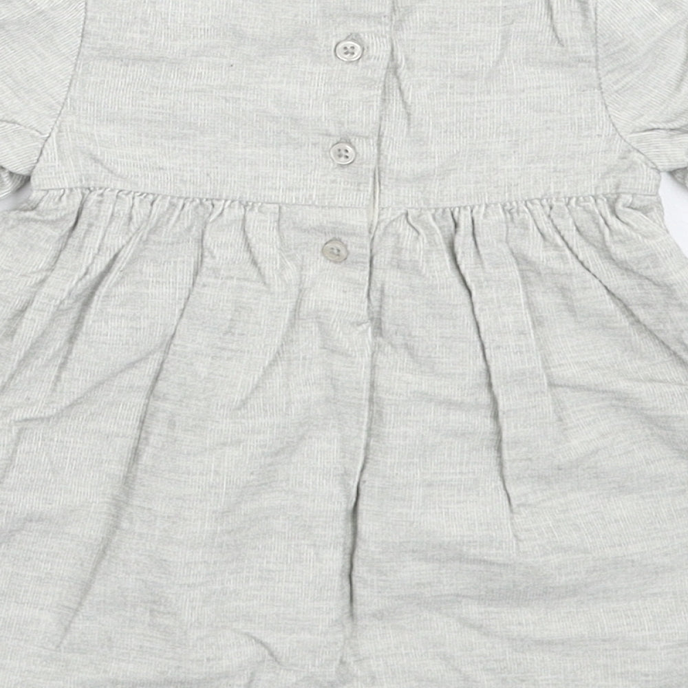 Brand and care label for Tu girls’ grey corduroy fit & flare, size 6-9, months