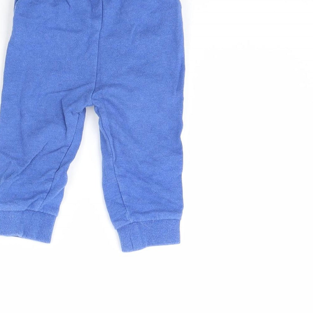 Brand and care label for Mini Club boys’ blue jogger trousers, size 9, months