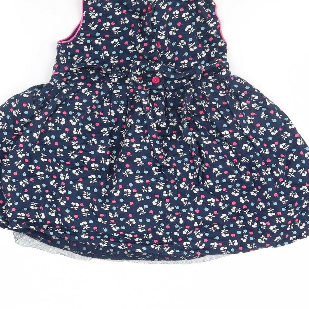 Brand and care label for Monsoon girls’ blue polka dot fit & flare, size 6-9, months