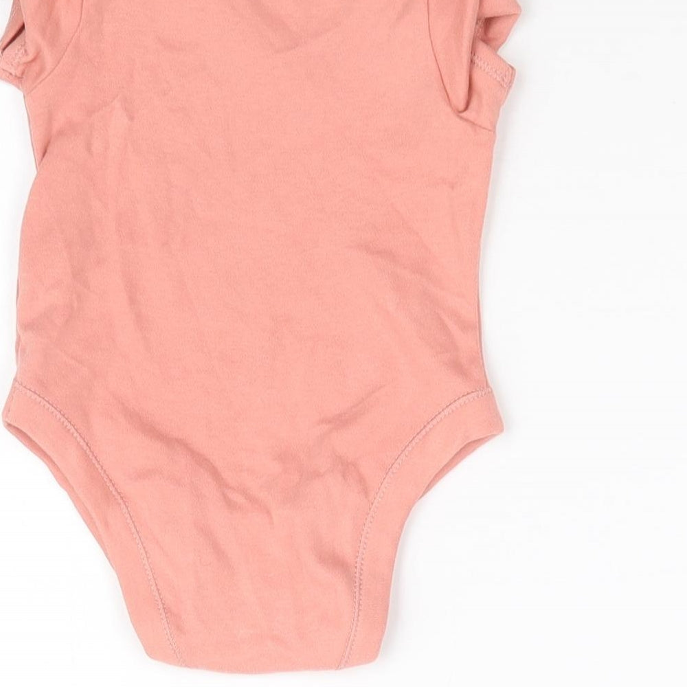 Brand and care label for George girls’ pink babygrow one-piece, size 3-6, months