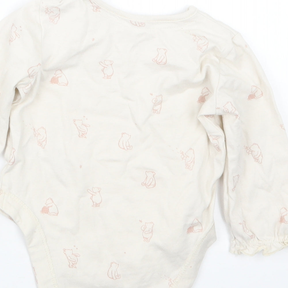 Brand and care label for George girls’ beige geometric babygrow one-piece, size 6-9, months - winnie the pooh