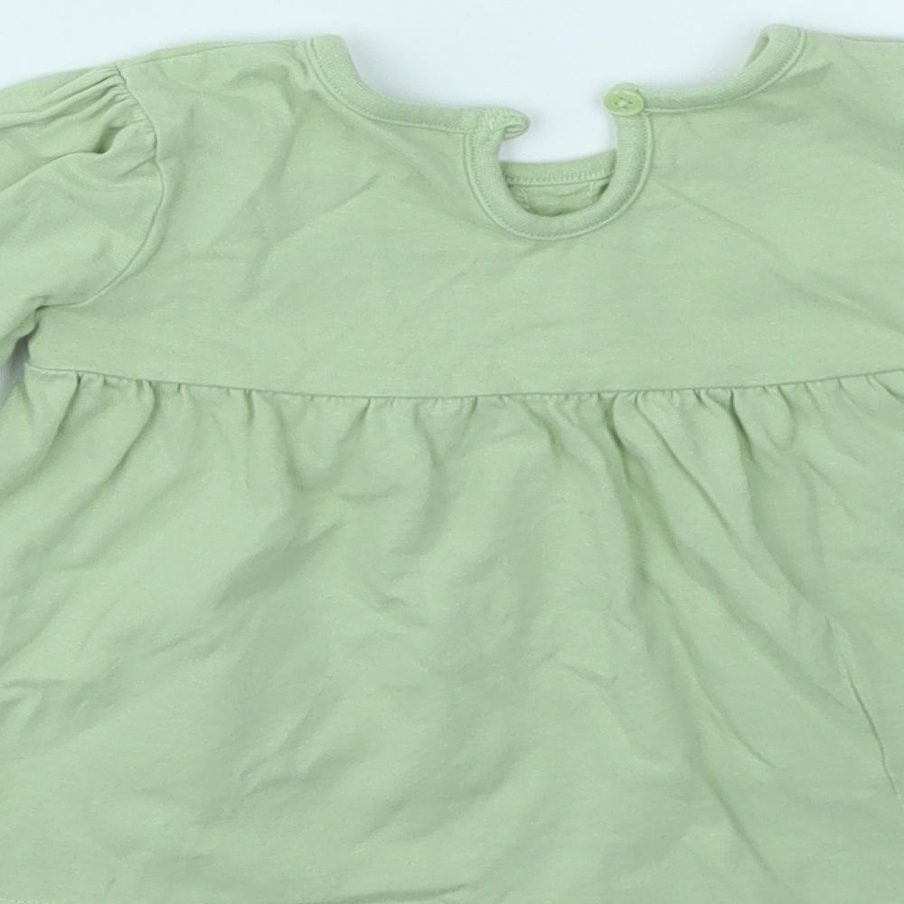 Brand and care label for George girls’ green camisole t-shirt, size 9-12, months