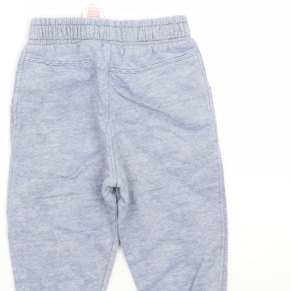 Brand and care label for F&F boys’ blue striped sweatpants, size 6-9, months