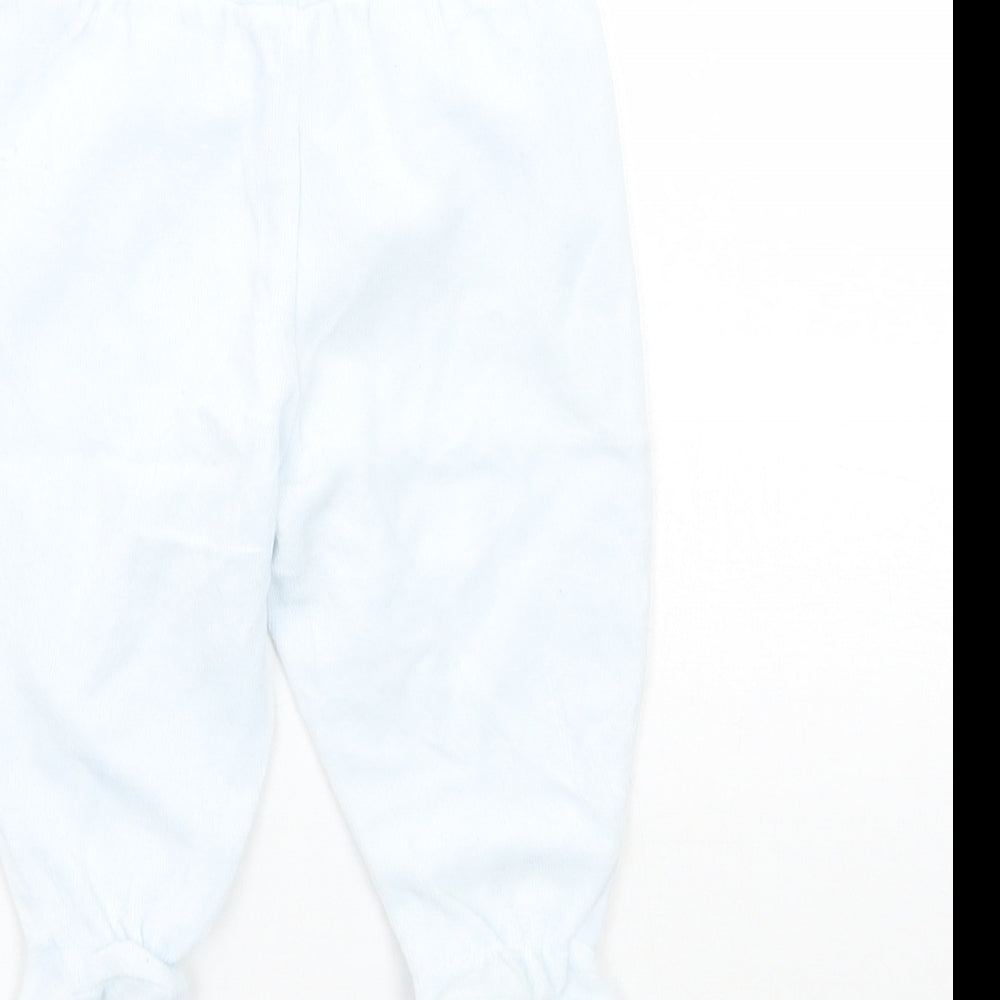 Brand and care label for Tutto Piccolo boys’ blue sweatpants, size 6-9, months