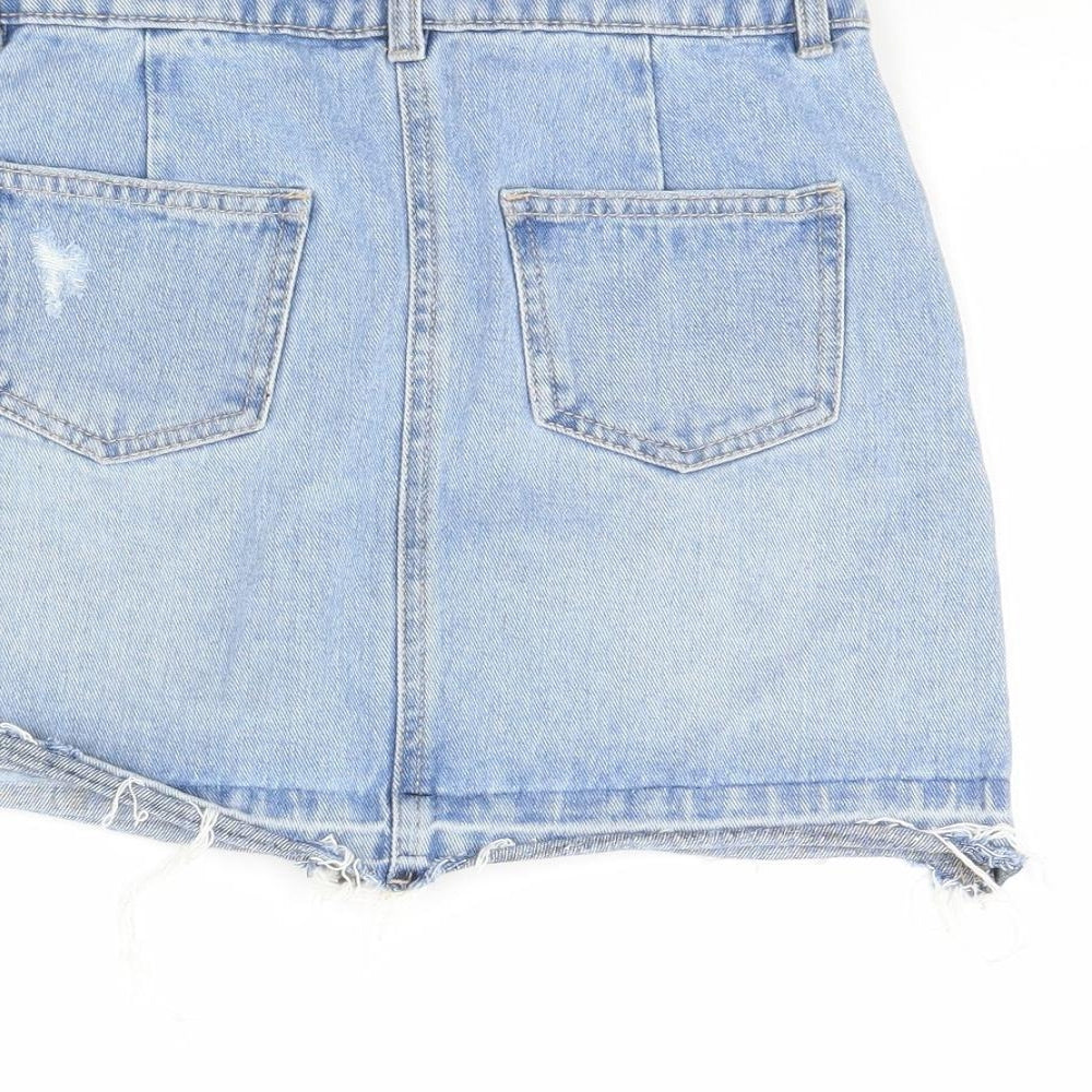 Brand and care label for Candy Couture girls’ blue denim mini skirt, size 9, years