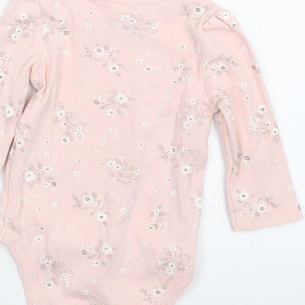 Brand and care label for So Cute girls’ pink floral babygrow one-piece, size 3-6, months