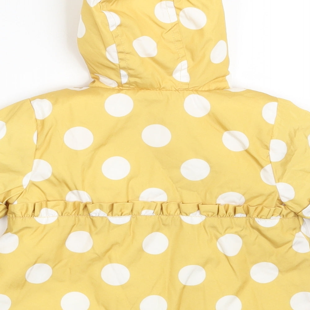 Brand and care label for Nutmeg girls’ yellow polka dot jacket coat, size 0-3, months
