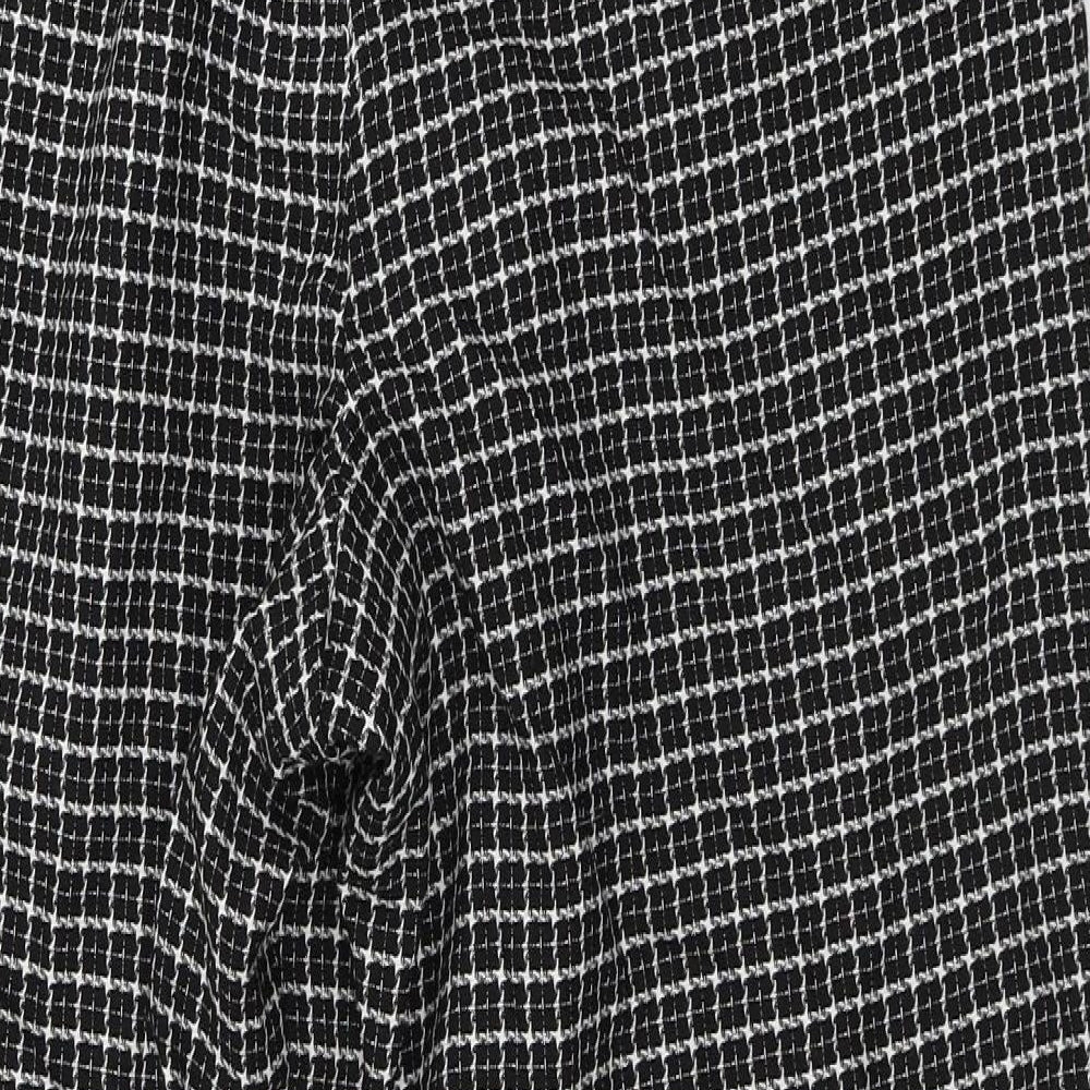 Brand and care label for Heart and Dagger women’s black floral trousers, size UK 32, in, 24-inch leg
