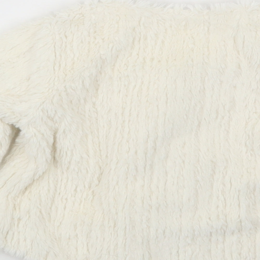 Brand and care label for Next girls’ white cardigan jumper, size 6-9, months