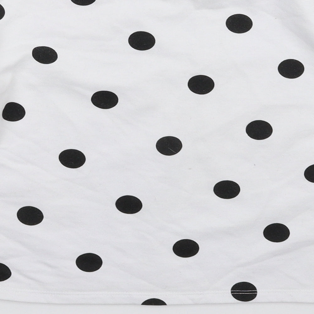 Brand and care label for Primark girls’ white polka dot pullover sweatshirt, size 10-11, years