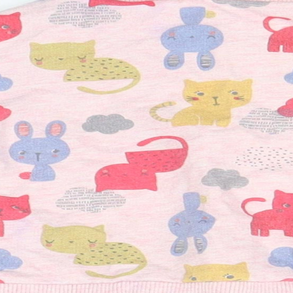 Brand and care label for Nutmeg girls’ pink jumper, size 3-6, months