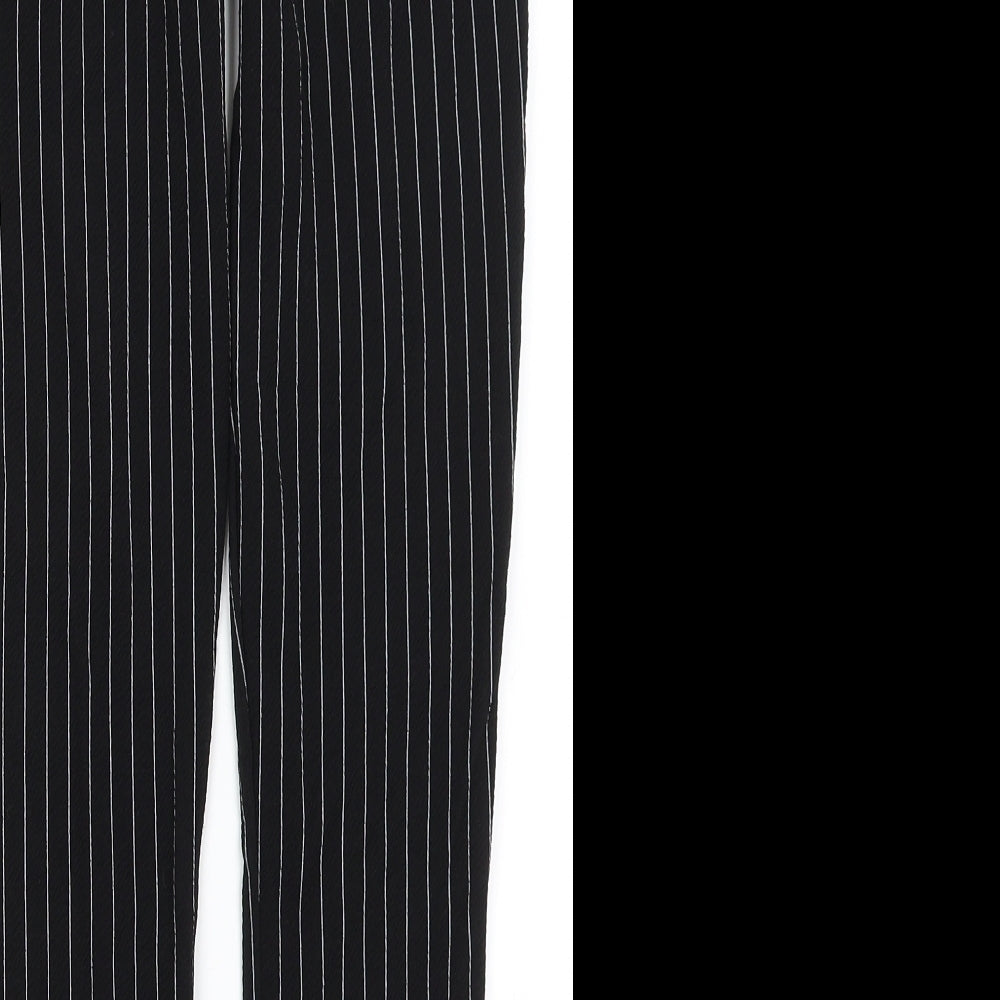 Brand and care label for PRETTYLITTLETHING women’s black striped trousers, size UK 4, 23-inch leg