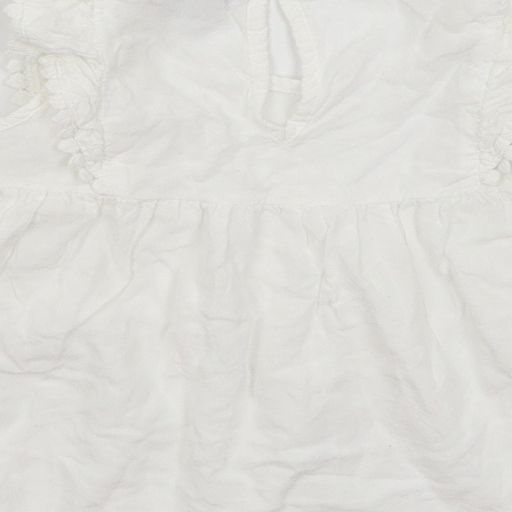 Brand and care label for Primark girls’ white basic blouse, size 4-5, years