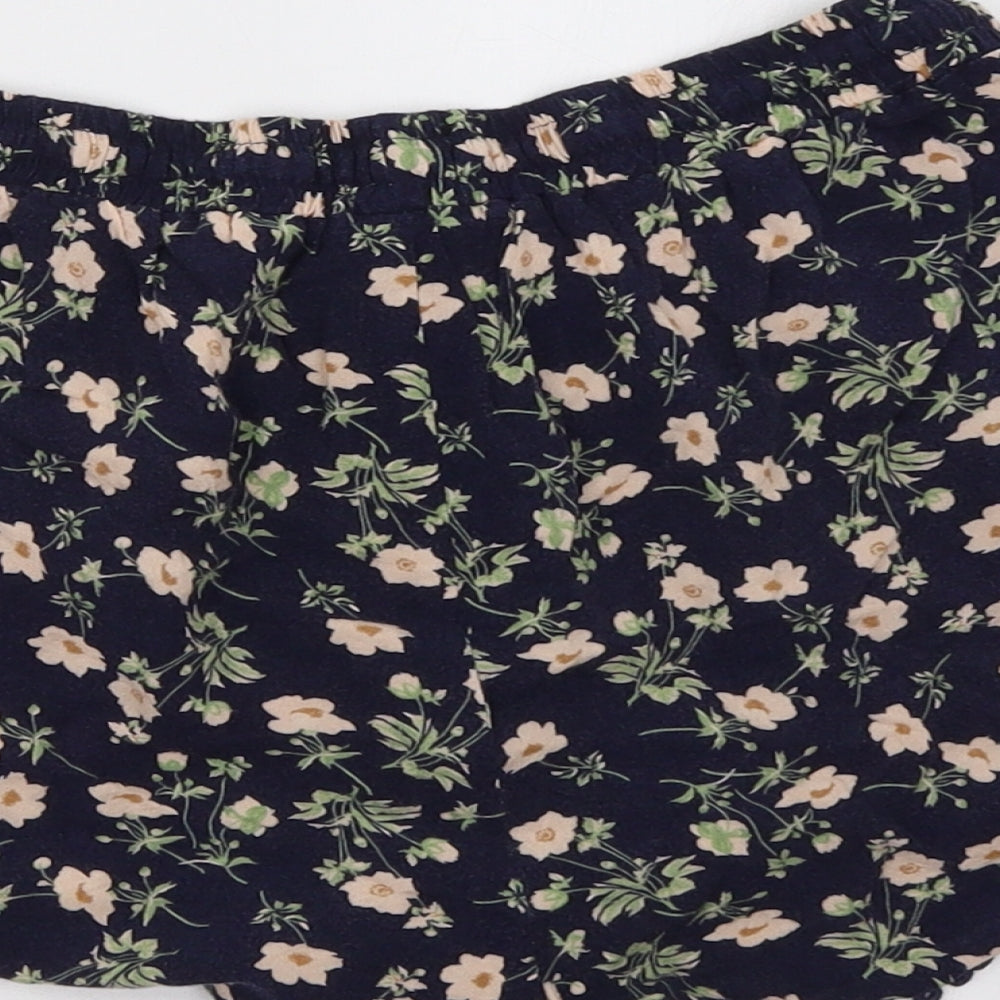 Brand and care label for Primark women’s blue floral sweat shorts, size UK 10