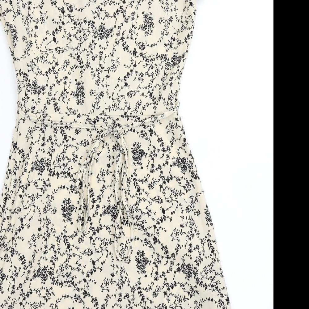 Brand and care label for Missguided women’s ivory floral fit & flare, size UK 4
