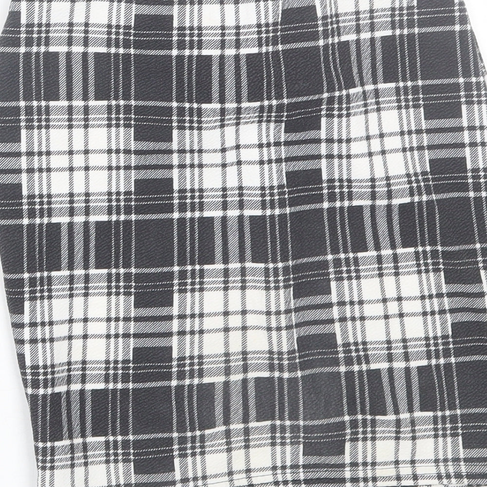 Brand and care label for PRETTYLITTLETHING women’s black plaid wrap skirt, size UK 6