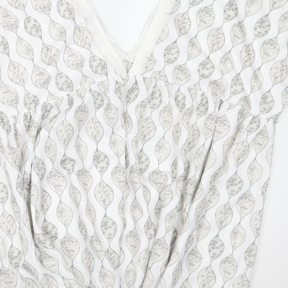 Brand and care label for Cupshe women’s white floral a-line, size S