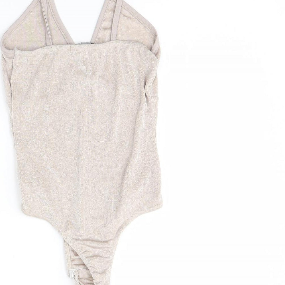 Brand and care label for PRETTYLITTLETHING women’s beige bodysuit one-piece, size UK 10