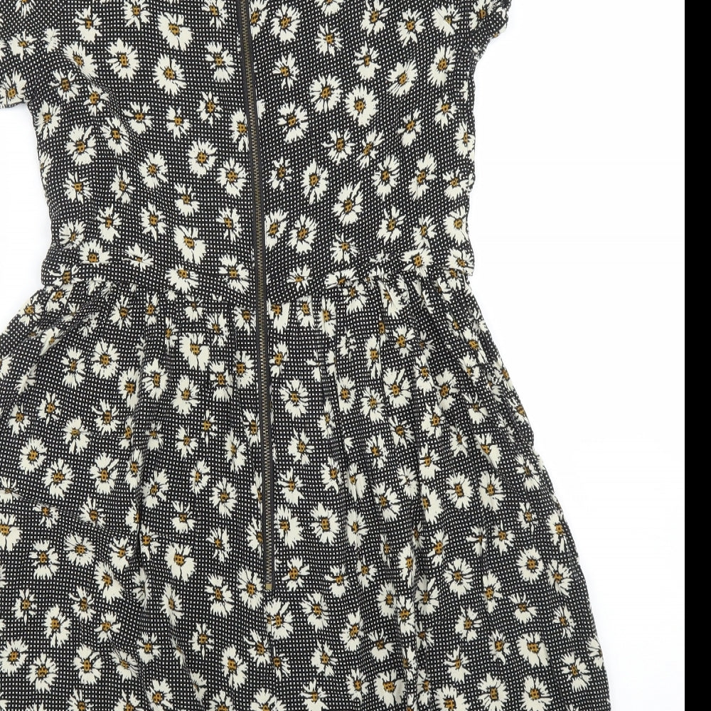 Brand and care label for Topshop women’s black floral a-line, size UK 6