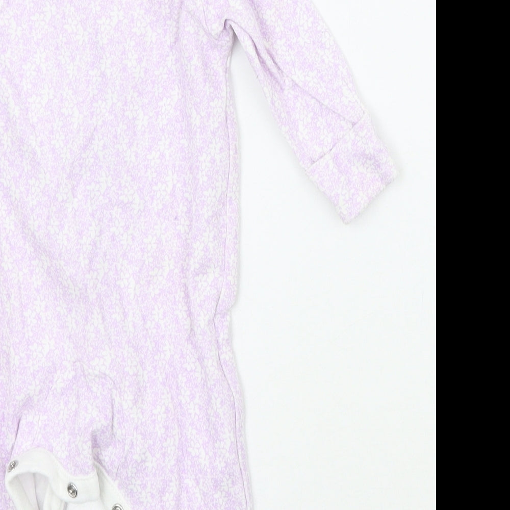 Brand and care label for Tu girls’ purple floral babygrow one-piece, size 0-3, months