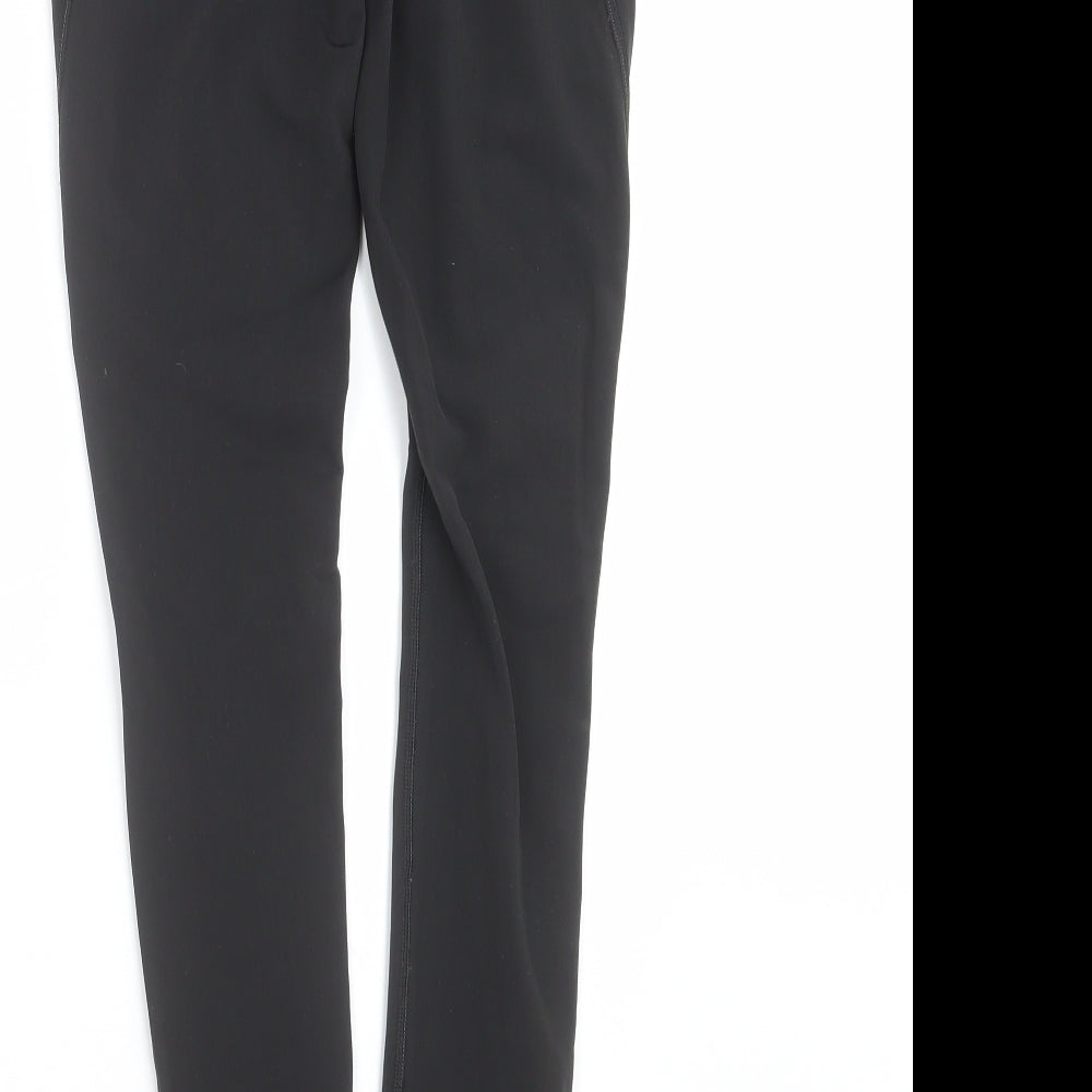 Brand and care label for Decathlon women’s black compression leggings, size XS, 29-inch leg