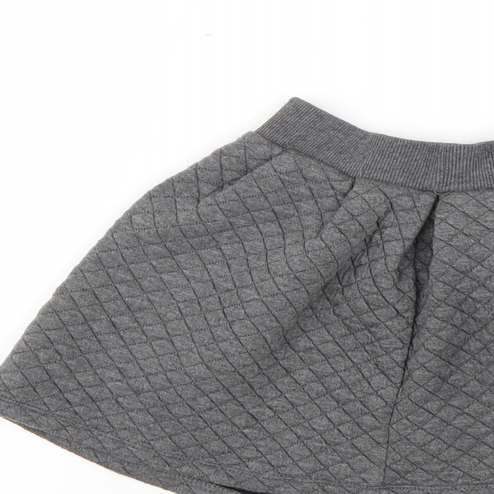 Brand and care label for Tu girls’ grey mini skirt, size 7, years