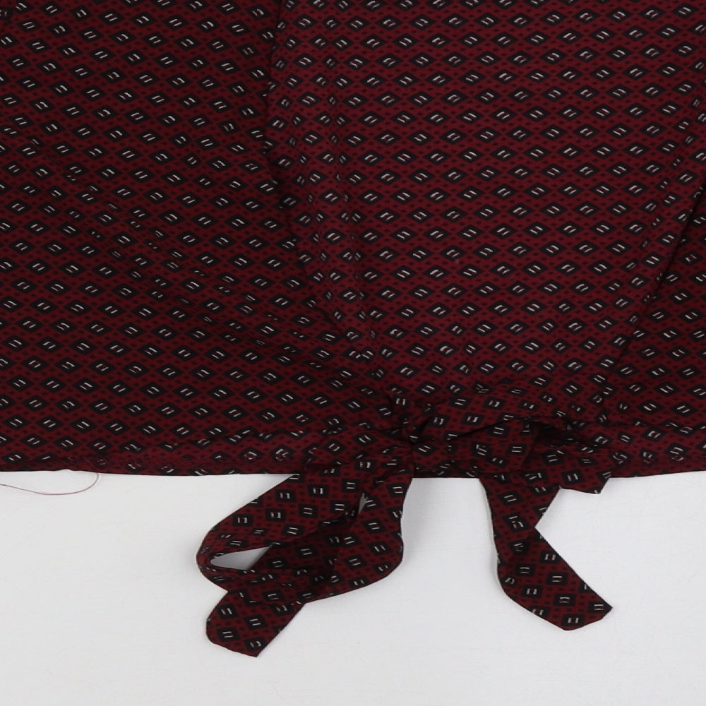 Brand and care label for Boohoo women’s purple geometric cropped blouse, size UK 14