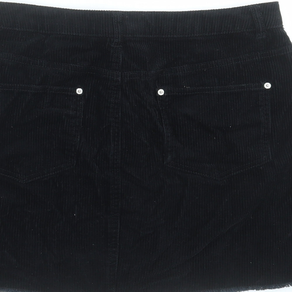 Brand and care label for Miss Selfridge women’s black corduroy a-line skirt, size UK 12, - distressed hem