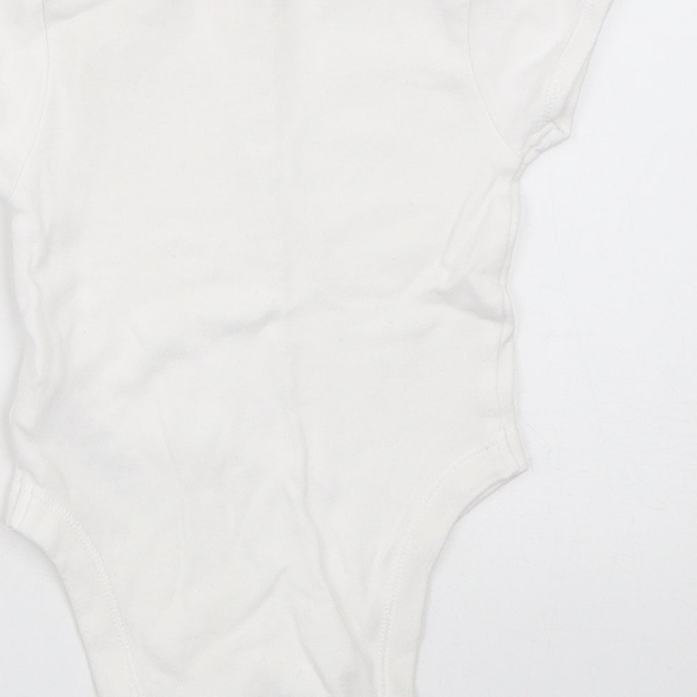 Brand and care label for Primark girls’ white babygrow one-piece, size 3-6, months