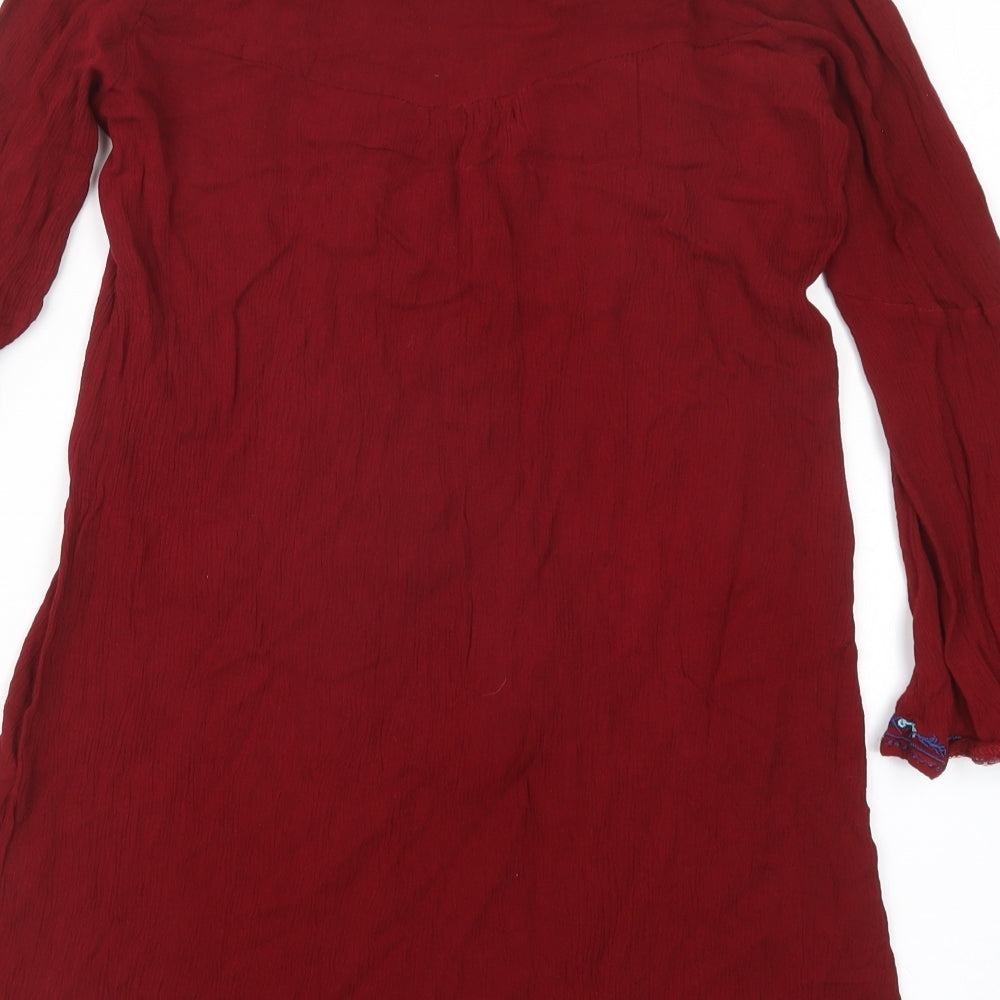 Brand and care label for Kiss the Sky women’s red basic blouse, size XS