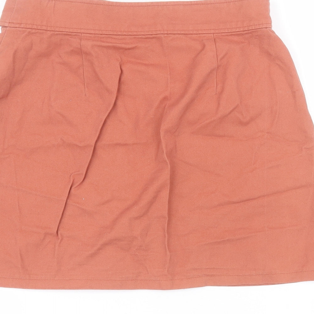 Brand and care label for Primark women’s orange cotton a-line skirt, size UK 8