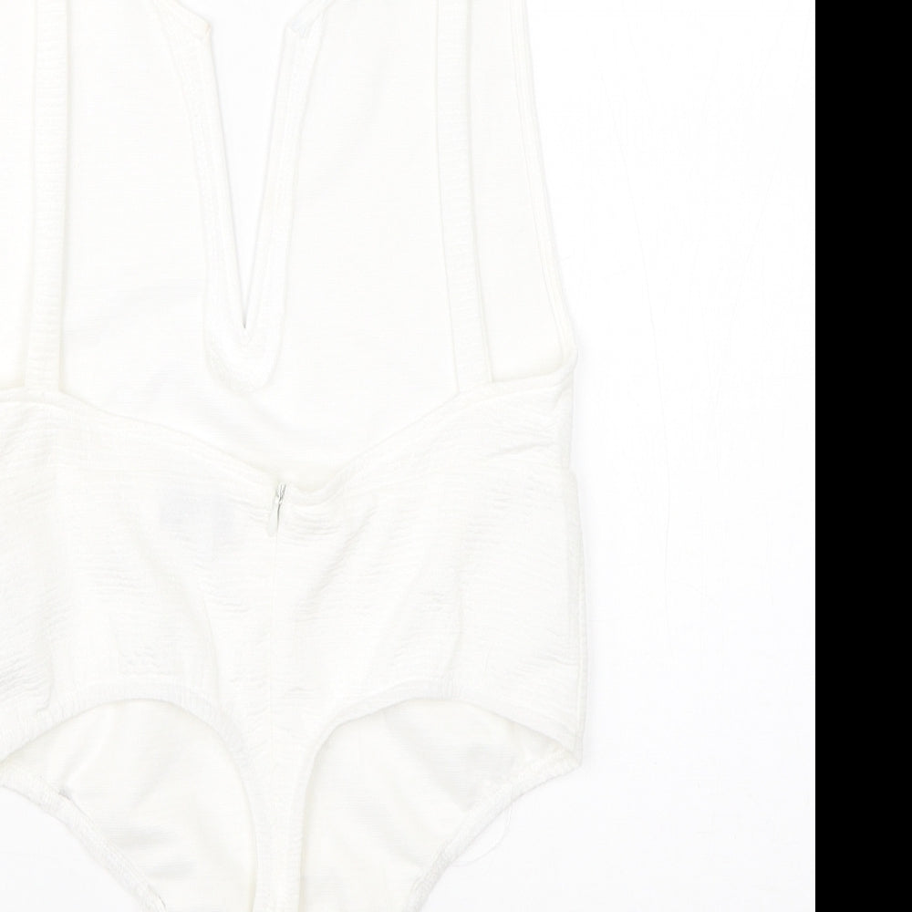 Brand and care label for In the Style women’s white polyester romper one-piece, size UK 10
