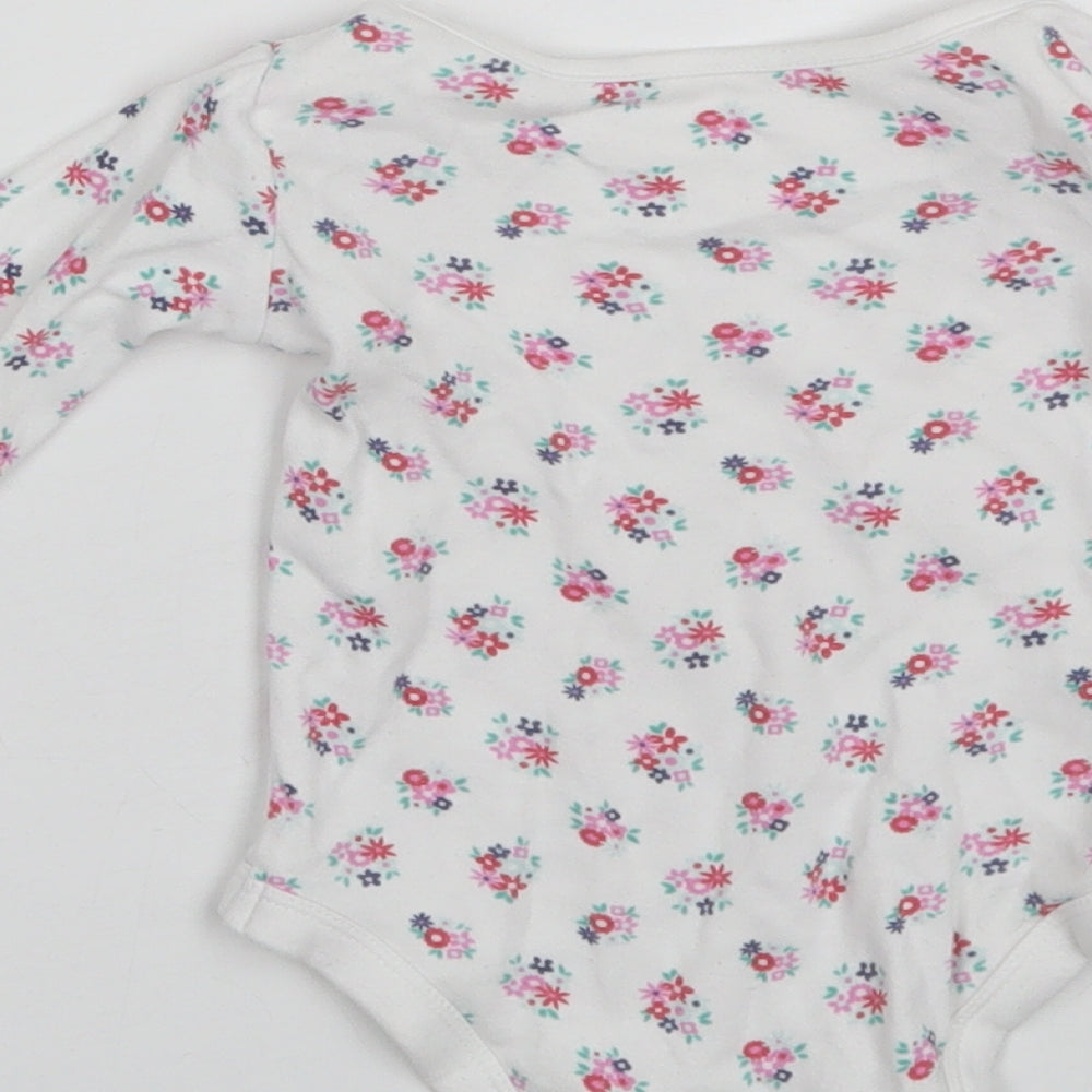Brand and care label for Tu Baby White Floral Cotton Romper One-Piece, size 6-9, Months