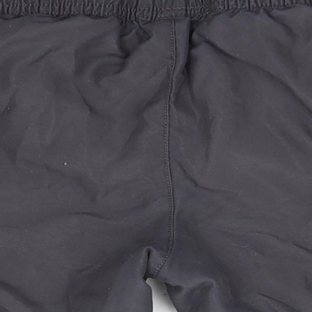 Brand and care label for George boys’ green polyester utility shorts, size 6-7, years regular
