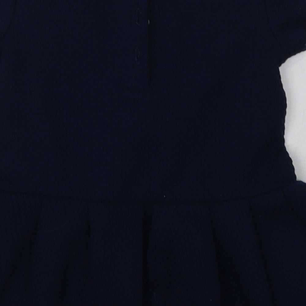 Brand and care label for Next girls’ blue polyester a-line, size 9-12, months crew neck button